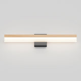 Minimalist wall-mounted light fixture with a long horizontal bar featuring a wood-like top and a glowing white underside, attached to a rectangular black base against a plain light gray wall.