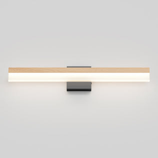 The Artika Neil modern LED bathroom vanity light features a minimalist design with a rectangular wooden accent atop a long, horizontal frosted diffuser, all mounted on a small black square base against a white wall.