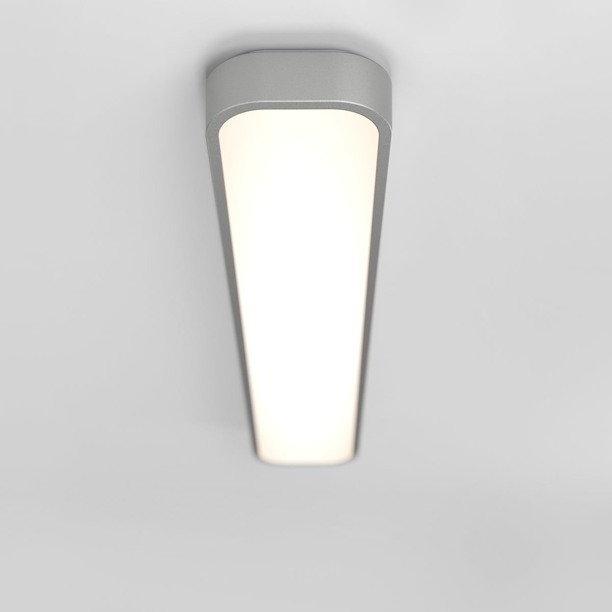 A modern, rectangular ceiling light fixture with rounded edges, mounted on a white ceiling and emitting a bright, even glow.