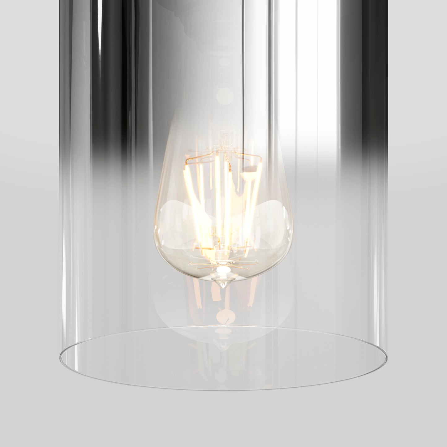 The Artika Haze pendant light glass features a glowing vintage-style bulb in a clear cylindrical fixture, set against a light gray background.