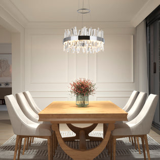 A modern dining room featuring a wooden table, six upholstered chairs, a vase of pink flowers at the center, large curtained windows, and the Artika Enchanted LED pendant light overhead.