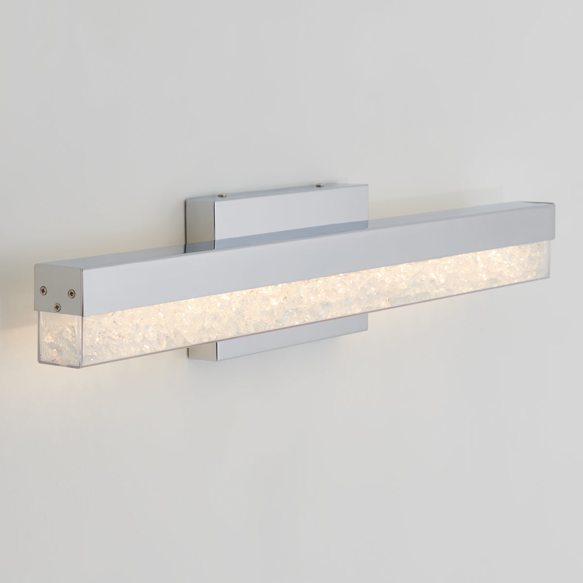 The Artika Riviera modern LED bathroom vanity light features a chrome finish and a textured, illuminated glass bar.