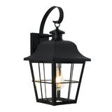 Black metal outdoor wall lantern with a curved top, clear glass panels, and a single exposed light bulb inside. The lantern is mounted to a wall bracket and features a decorative loop at the top.