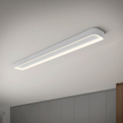 An Artika Aiden 48 in. LED modern flush mount light (5 CCT) is installed on a white ceiling above a room featuring gray cabinets and a glimpse of a wooden panel.