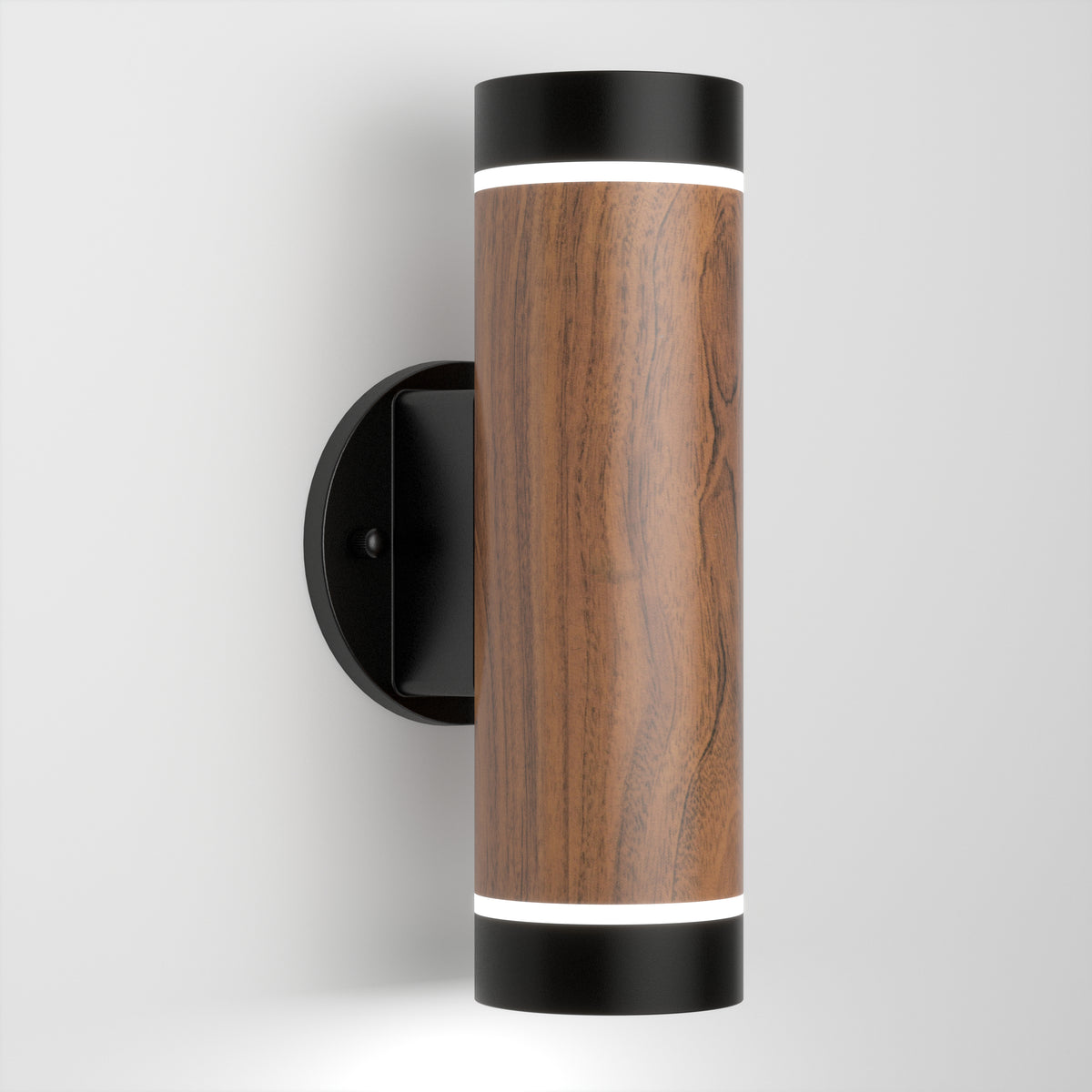 The Artika C7 indoor-outdoor LED wall light 3 CCT features a cylindrical design with a wood grain finish, black end caps, top and bottom lighting, and is mounted on a round black wall plate against a white background.