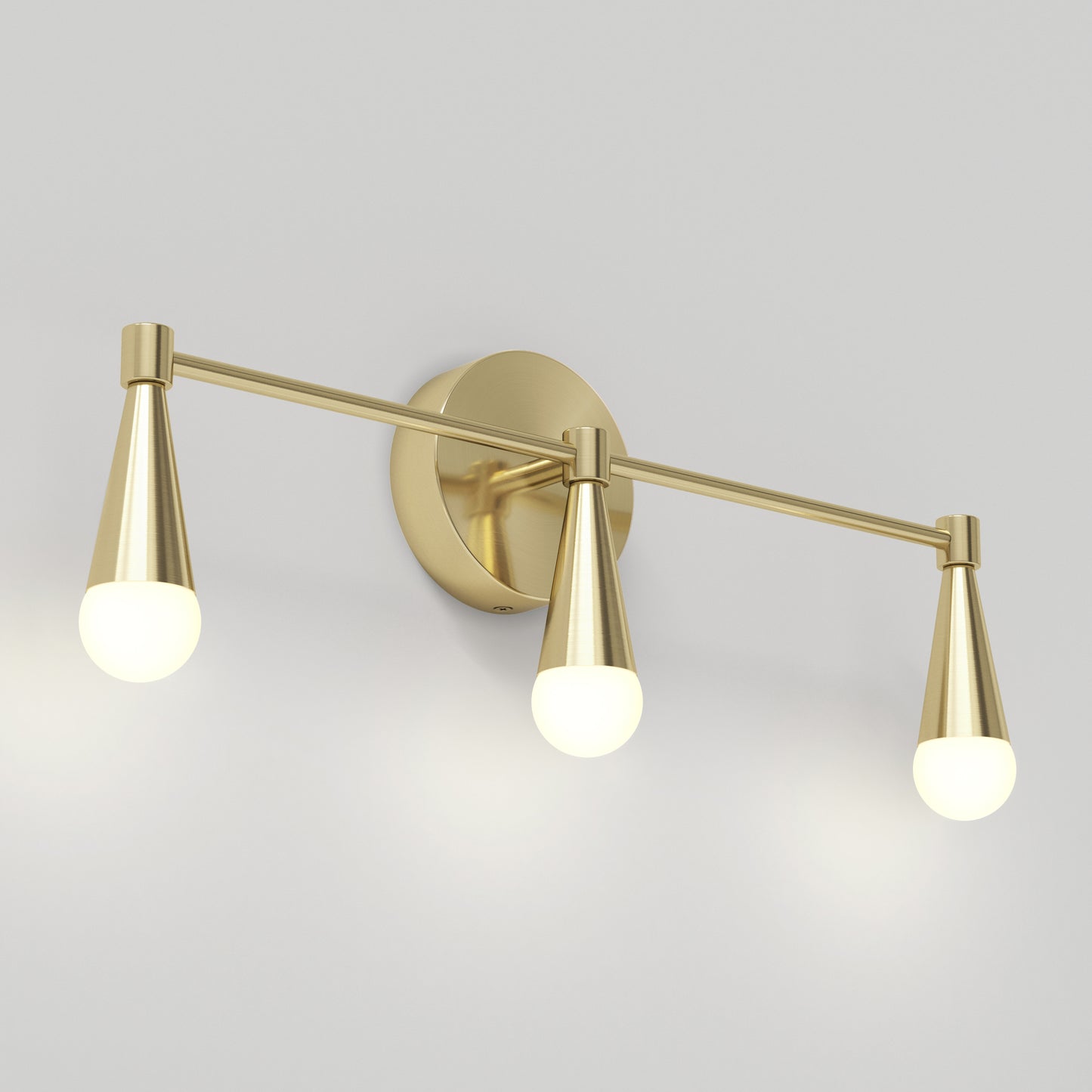 The Artika Wayden LED mid-century bathroom vanity light features three brass cone sockets with round white bulbs, arranged horizontally. This modern wall-mounted fixture offers 3 selectable color temperatures.
