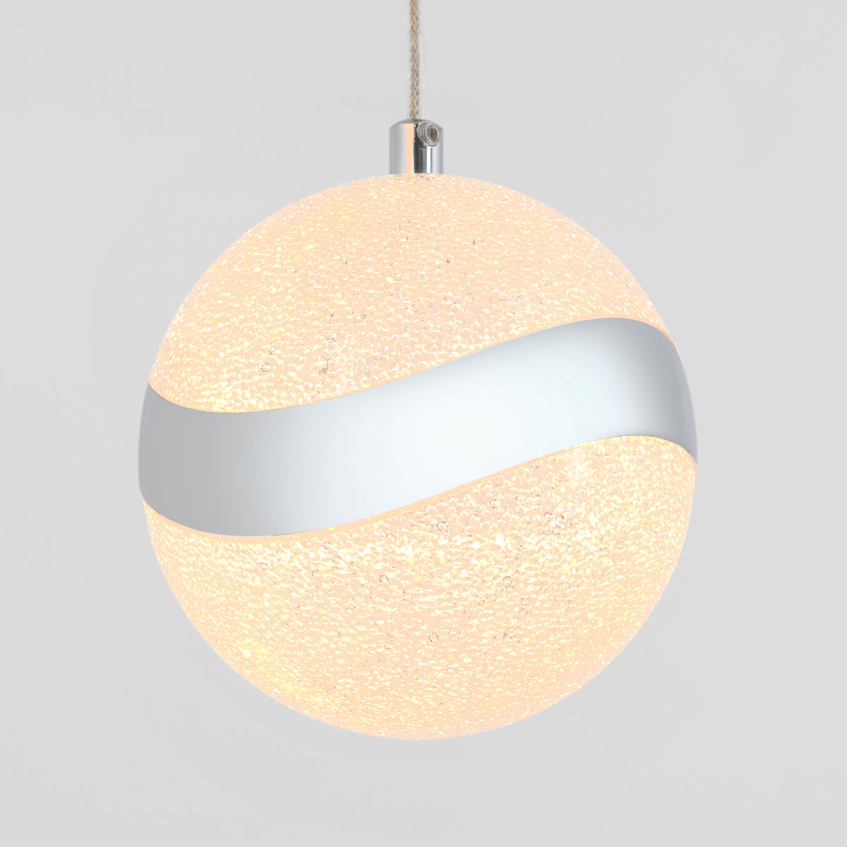 A spherical pendant light with a textured, glowing surface and a metallic silver band wrapping around its middle, hanging from a cord against a plain background.