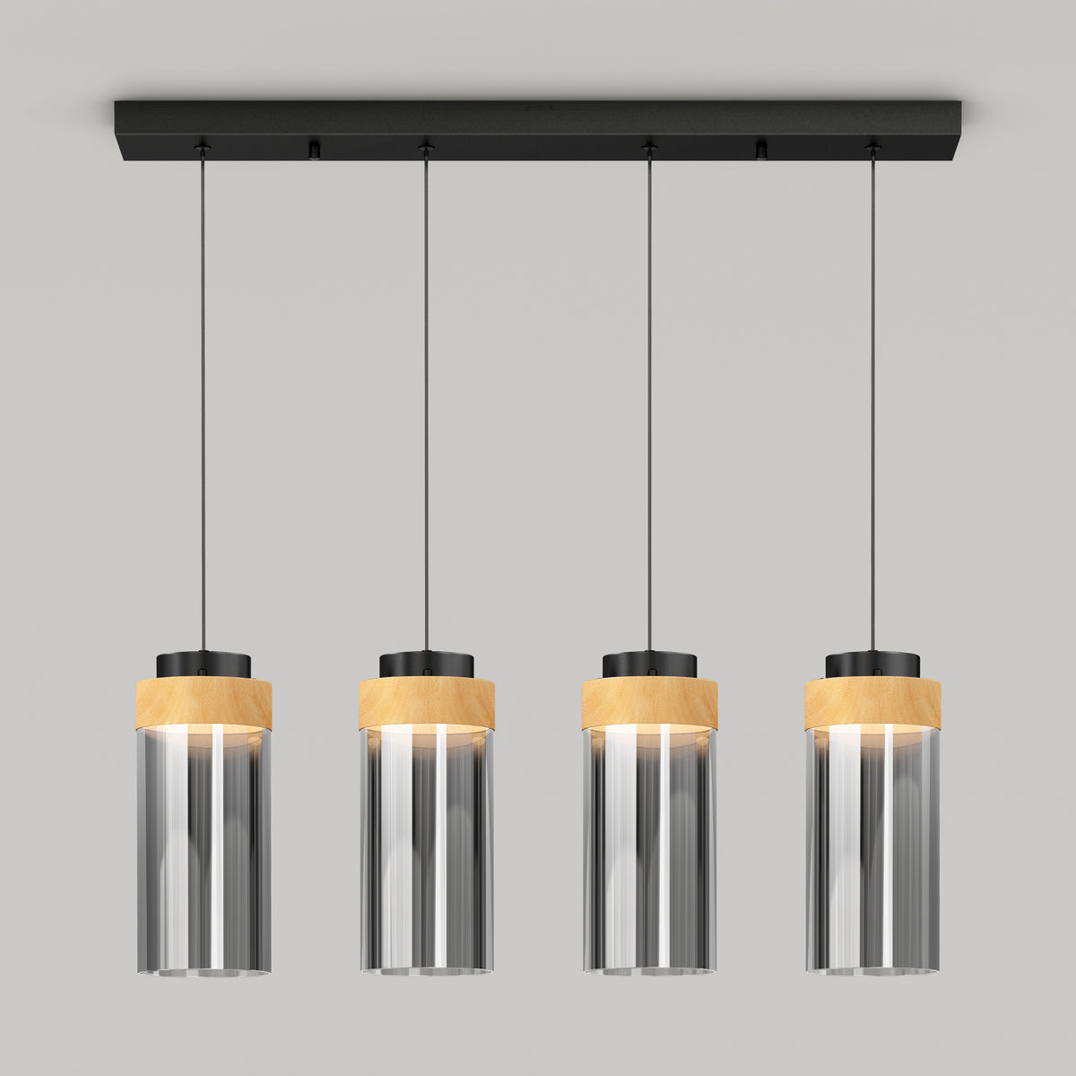 The Artika Hanson 4-light LED pendant features cylindrical glass shades, black fixtures, and light wood accents, suspended in a row from a rectangular black ceiling mount against a plain light gray background.