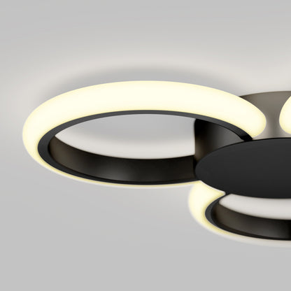A close-up of the Artika Nyala 15 in. LED flush mount light 5CCT features circular LED rings emitting a soft white glow against a light gray background.
