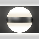A round, white light fixture is mounted on a black wall with a horizontal black band across its center, creating a modern and minimalist geometric design.