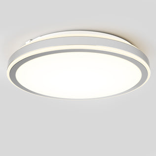 The Artika Altitude 15 in. LED modern flush mount light features a circular, minimalist design and 5 adjustable color temperatures, casting bright white light on a light gray ceiling.