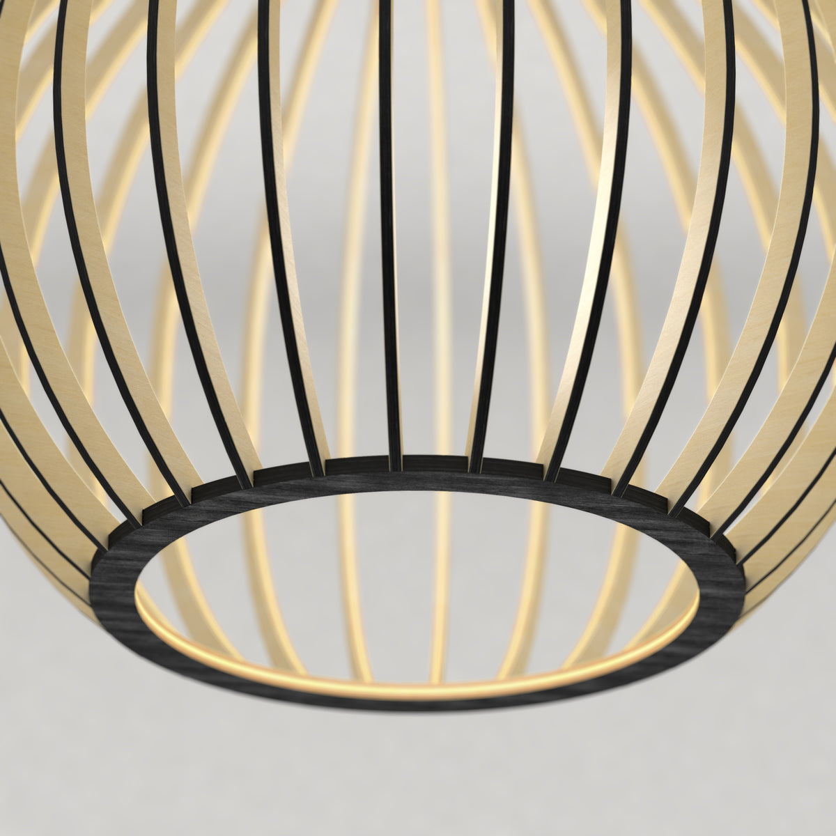 Close-up of a modern, circular pendant light fixture with curved, gold and black metal slats forming an open, cage-like structure against a plain, light background.