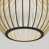 Close-up of a modern, circular pendant light fixture with curved, gold and black metal slats forming an open, cage-like structure against a plain, light background.