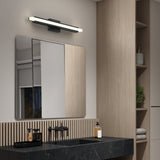 Modern bathroom with light wood paneling, a black marble countertop, a square mirror, a rectangular LED wall light above the mirror, black faucet fixtures, a soap dispenser, and shelves with a plant.