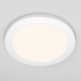 A round, white LED ceiling light fixture with a soft, diffused glow, mounted on a plain, light gray ceiling.