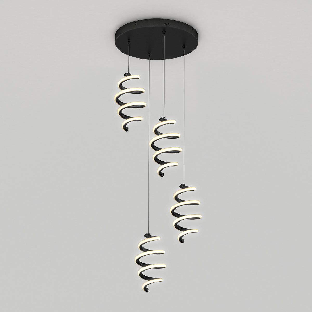 The Artika Chorus 4 light LED pendant features three spiral-shaped lights hanging from a round black base, emitting a soft white glow. Its modern design complements any space with adjustable color temperatures (5 CCT).