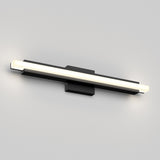 A modern wall-mounted LED light fixture with a horizontal, rectangular design in black and white, emitting a soft glow at both ends against a plain light gray wall.