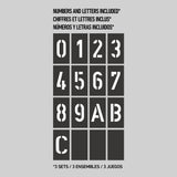 A black stencil set on a gray background displays the numbers 0–9 and the letters A, B, and C. Text above reads Numbers and letters included in English, French, and Spanish. Below: 3 sets / 3 ensembles / 3 juegos.