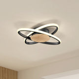 Modern ceiling light fixture with circular LED rings and a wooden central base, mounted on a white ceiling in a minimalistic room.
