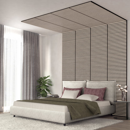 A modern bedroom features a large bed with neutral bedding, purple accent pillows, a green throw, tall curtains, a houseplant, decor on the bedside table, and Artikas Sonolok 15.5 ft sound-absorbing wall panel kit (4-pack) with floor-to-ceiling stripes.