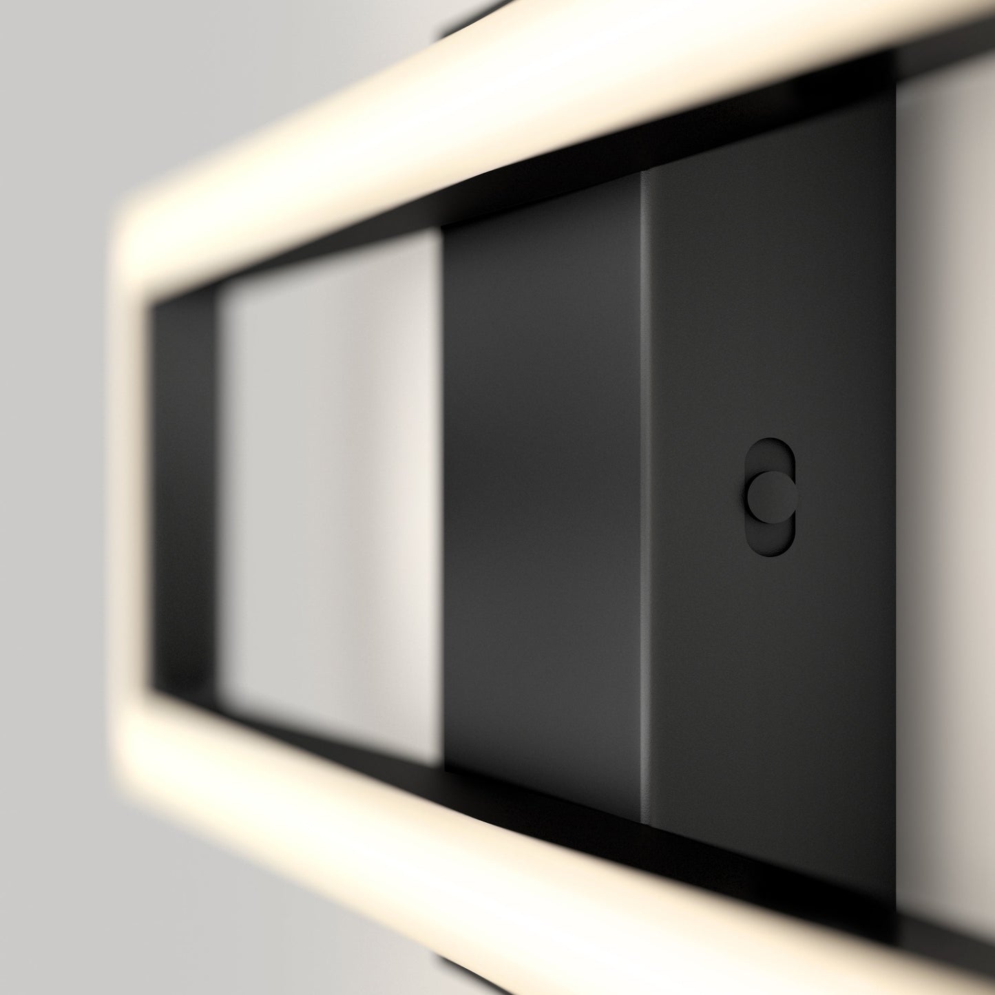 A close-up of the Artika-CAN-dev Dover modern LED bathroom vanity light 5 CCT, a sleek rectangular black fixture with soft white LED lighting around its frame, mounted on a light gray wall in a minimalist style.