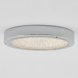 The Artika Glitter LED flush mount is a modern, round chrome light with a frosted glass center for energy-saving style.