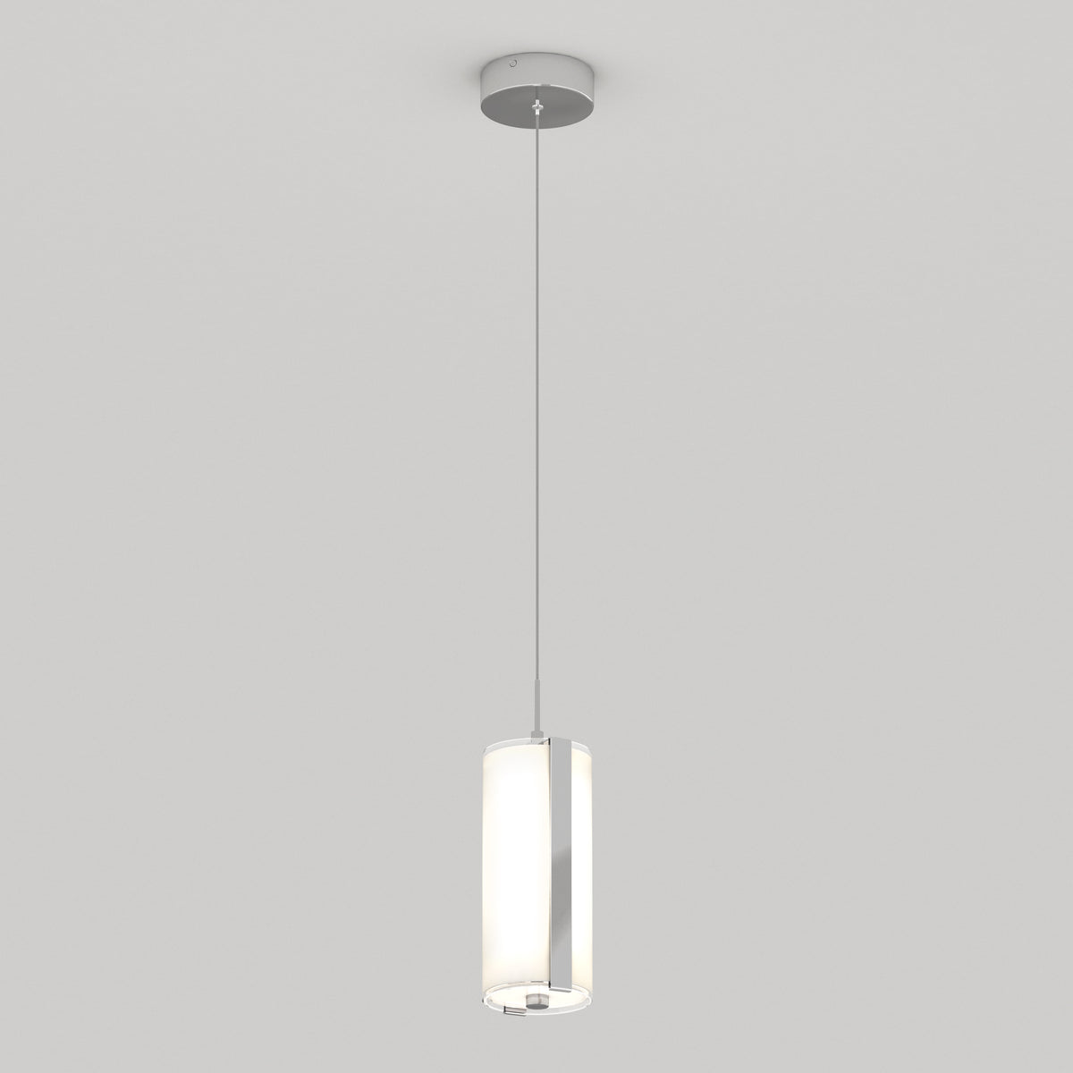 A modern pendant light fixture with a cylindrical frosted glass shade hangs from the ceiling by a thin cord against a plain white background.