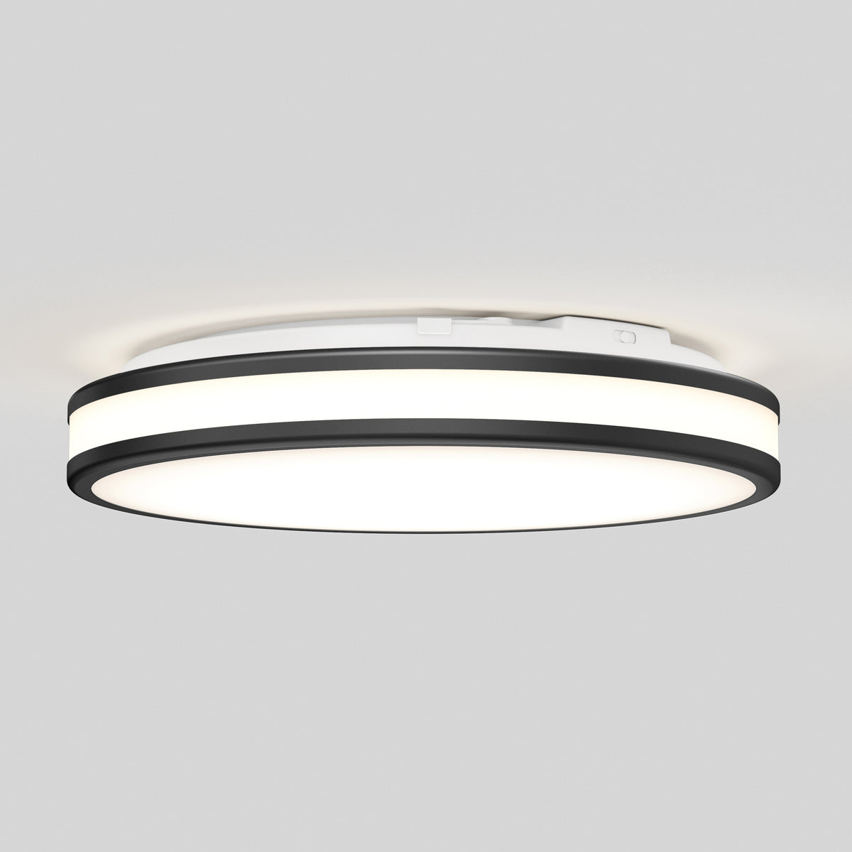 The Artika Hemisphere 15 in. LED flush mount light features a modern circular design with a white center and two black accent rings. Mounted on a light gray ceiling, its adjustable brightness delivers an even glow—perfect for bathroom lighting.