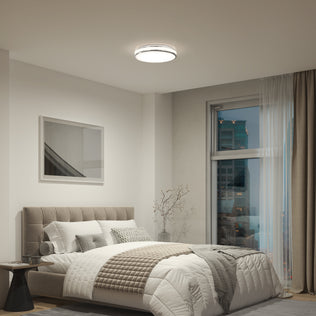 Modern bedroom with tufted bed, cozy bedding, side table, wall art, and Artika Hemisphere 15 in. LED ceiling light by city-view window.