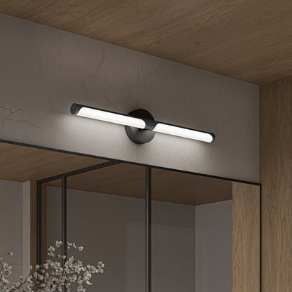 The Artika Ilona LED bathroom vanity light 5 CCT in black is wall-mounted above a mirror on a beige tiled wall with wooden accents, adding a modern touch to the bathroom.