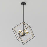A modern pendant light with four exposed bulbs set inside a geometric, open metal cube frame suspended from the ceiling. The frame combines black and gold finishes.