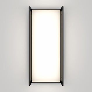 The Artika Ryker smart RGB indoor-outdoor wall light features a bright, glowing center framed by slim black side panels and is mounted on a plain light gray wall.