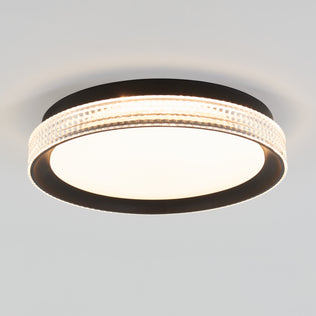 The Artika Aston 15 in. LED modern flush mount light features a black frame, textured clear ring, and white illuminated center, mounted on a plain white ceiling.