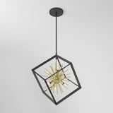 A modern pendant light with a black metal cubic frame surrounds a gold, starburst-style light fixture, hanging from the ceiling against a plain white background.