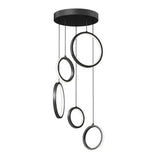 A modern black ceiling light fixture features five hanging rings at varying heights, each ring illuminated on the inner edge, suspended from a round ceiling mount by thin black wires.