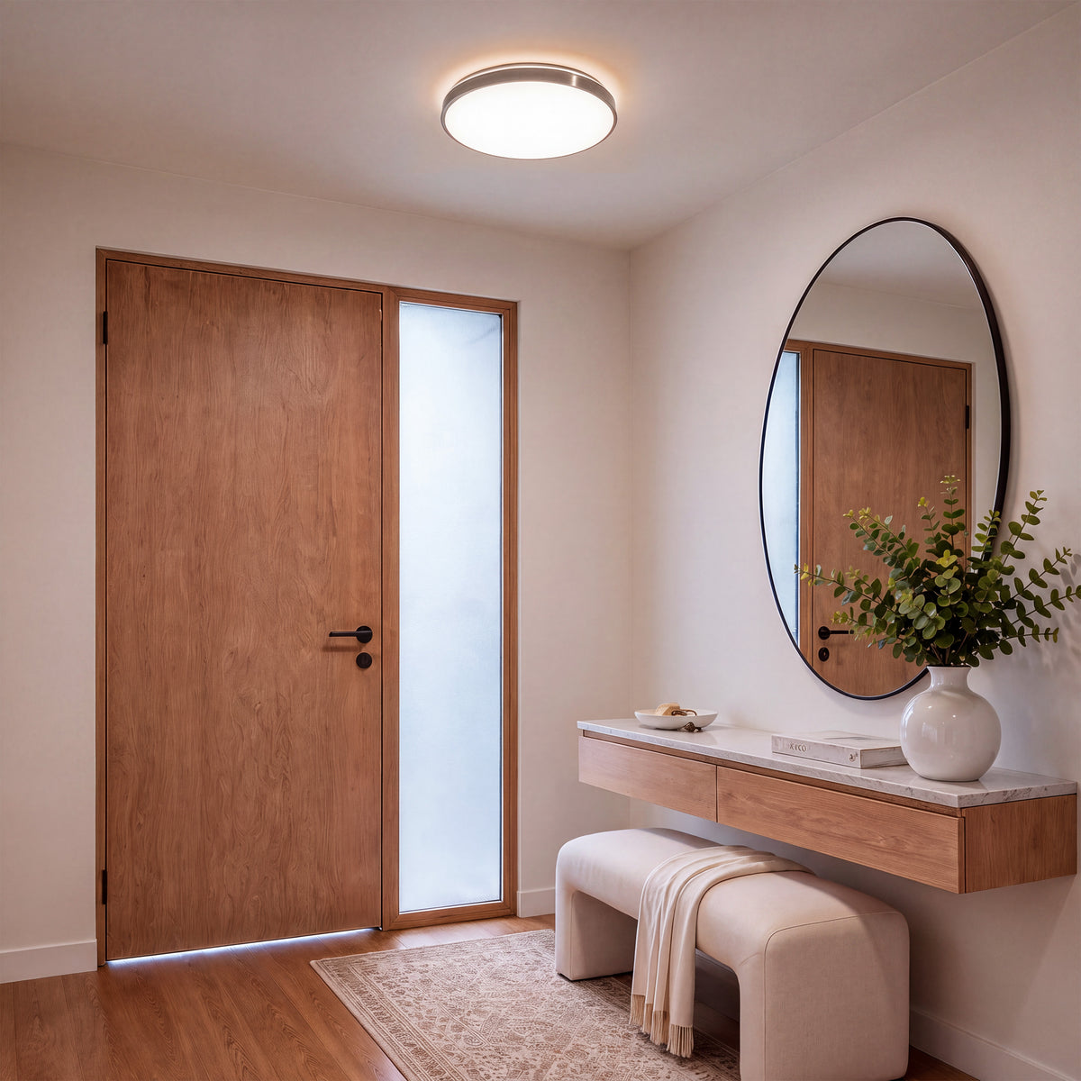 Minimalist entryway featuring Artika’s Isara 15 in. RGBIC LED Flush Mount for stylish, modern lighting above a wooden door and console.