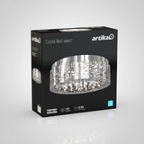 A black Artika box displays the Crystal Nest LED ceiling light fixture with a detailed image of the light’s intricate, nest-like design on the front. Packaging highlights LED, 1820 lumens, and 50,000-hour lifespan.