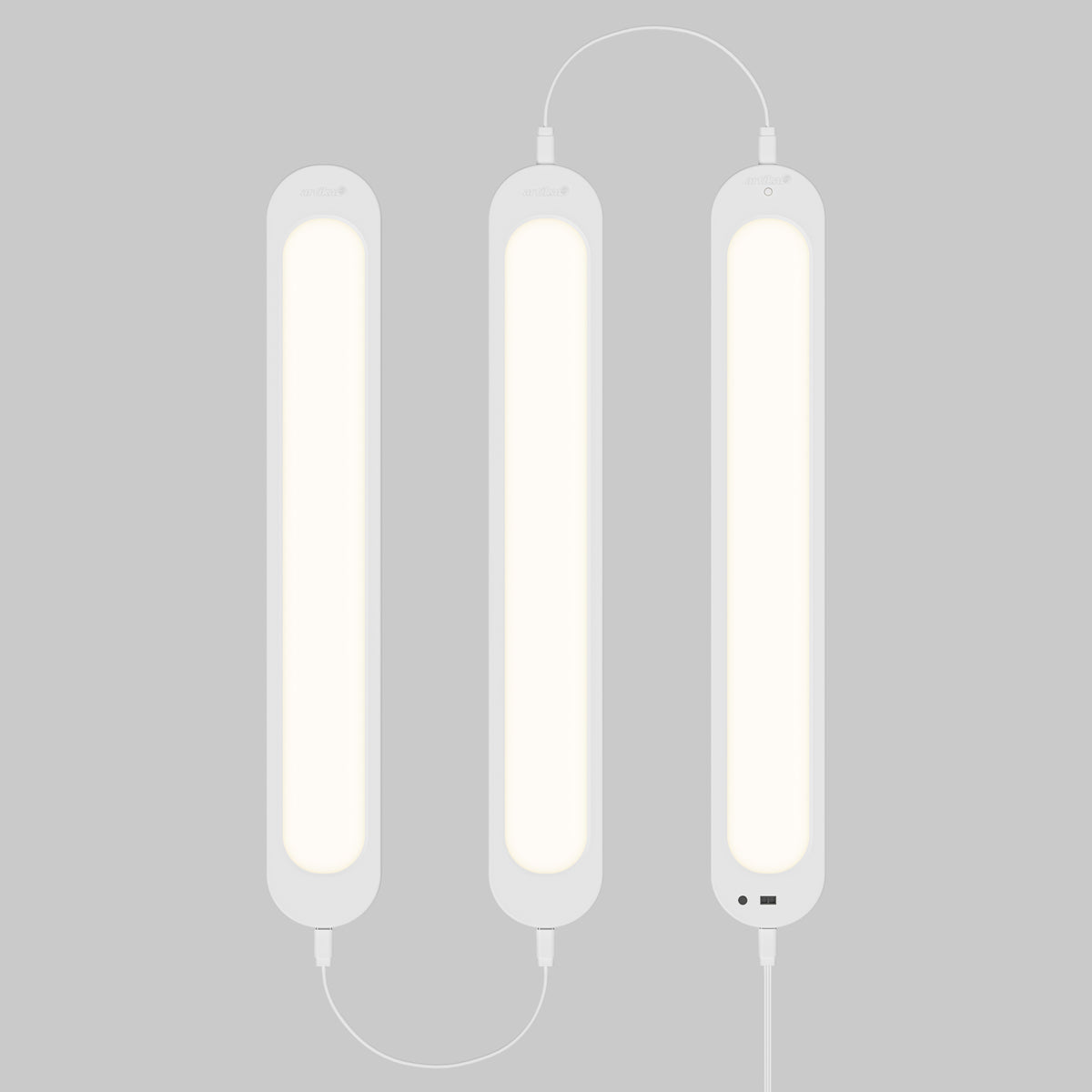 Artika Impulse Under-Cabinet LED Light RGB+CCT, three linked bars glow softly on gray, cables visible, includes remote.
