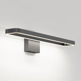 A modern, rectangular wall-mounted light fixture with a sleek black frame and integrated LED lighting, emitting a soft, even glow on a plain white wall.