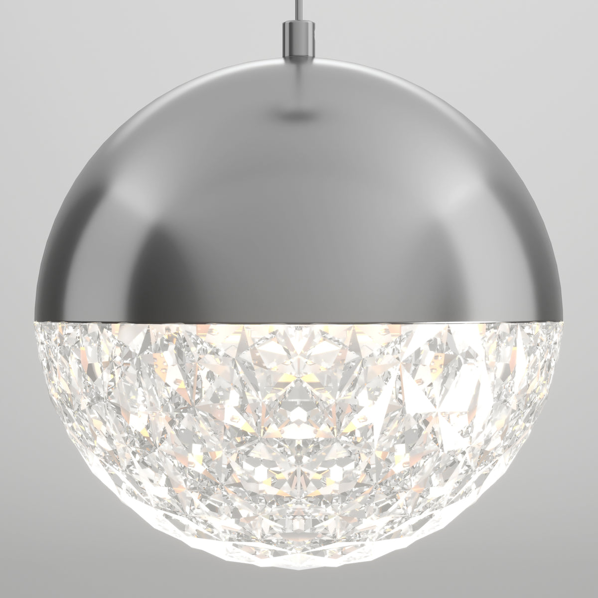 A spherical pendant light with a metallic top half and a faceted, crystal-like bottom half that glows brightly. The fixture hangs from a central rod against a plain, light background.