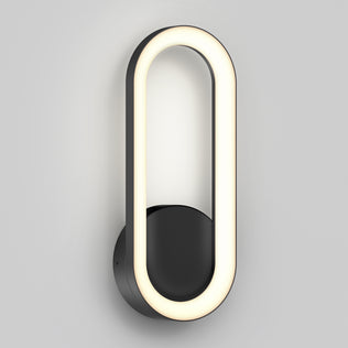 The Artika Aiden modern LED indoor-outdoor wall light 5 CCT features an oval-shaped illuminated LED ring on a round black base, displayed against a plain light gray background.