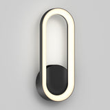 A modern wall light with an oval-shaped, glowing LED frame mounted on a circular black base, set against a plain light gray wall.