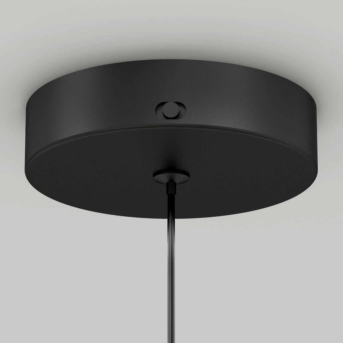 Close-up of the Artika Hanson 1-light LED pendant 5 CCTs black, round ceiling canopy with a smooth finish and a visible side screw, mounted on a white ceiling with its cable hanging from the center.