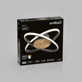 A black Artika box displays the Atomic LED ceiling light with interlocking rings and a wood finish base. Key features are shown, including brightness, energy efficiency, and lifespan.