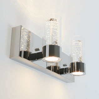 The Artika Ratio 2-light LED bathroom vanity light features a modern wall-mounted design with a rectangular chrome base and two bubble-detailed glass shades that emit bright, white light.