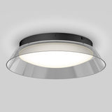 A modern ceiling light fixture with a black circular base, a frosted white diffuser, and a clear angled outer rim, emitting a soft, even glow against a light gray background.
