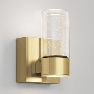 The Artika Essence 1-light LED bathroom vanity light features a modern brass finish and a clear bubble glass shade.