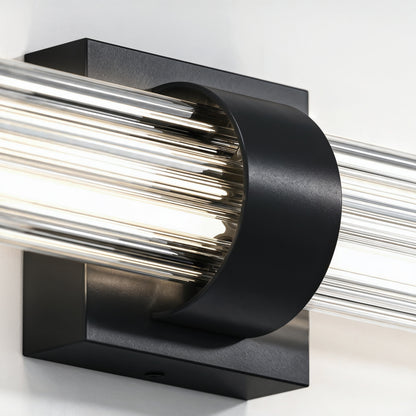 Close-up of the Artika Dorado 27 in. LED Wall Vanity with black base and clear cylindrical glass rods.
