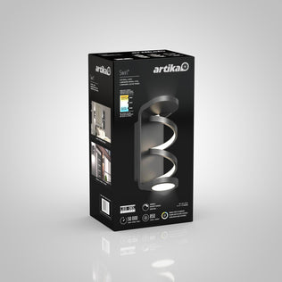 A black and grey box for the Artika Swirl indoor-outdoor LED wall light, featuring an image of the modern curved fixture plus details like energy savings, 50,000-hour lifespan, and 850 lumens brightness.