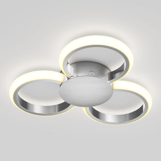The Artika Nyala 15 in. LED flush mount light features three circular rings arranged triangularly on a central metallic base, providing a soft white glow and modern style to any space.